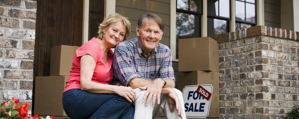 happy couple sitting on porch after moving